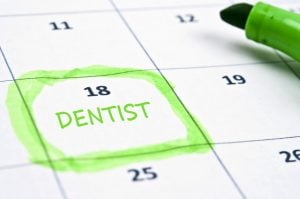Calendar with the word Dentist written on the 18th